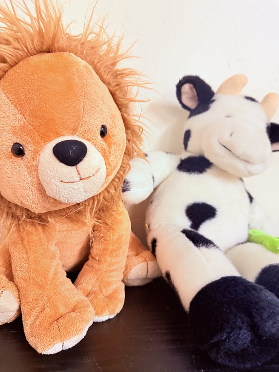 Soft toys — lion and cow — in the nursery at My Stars